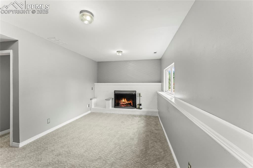 Image 8 of 21: Large Family Area with Fireplace