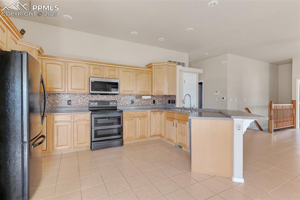 Image 12 of 43: Very wide open kitchen