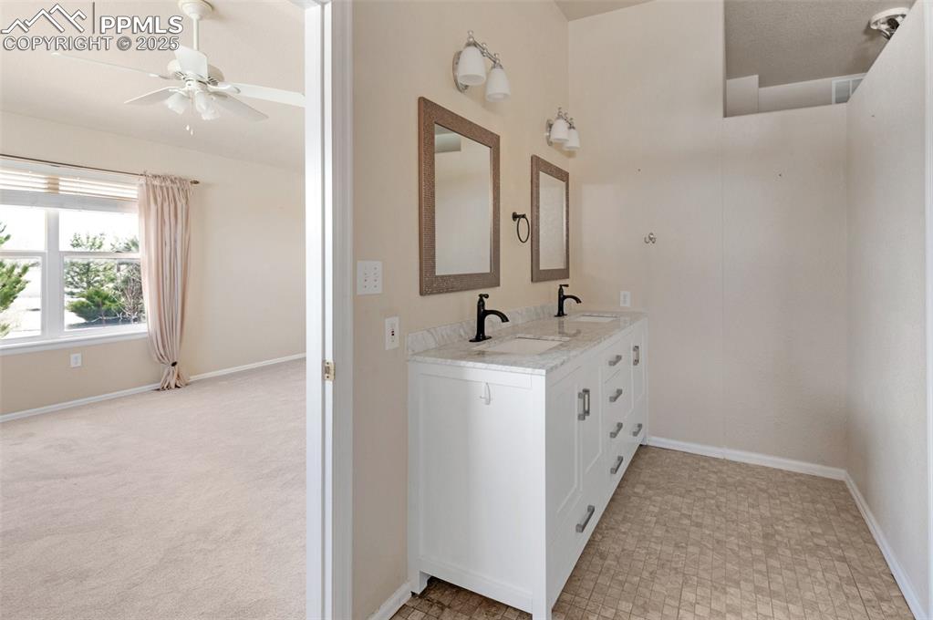 Image 20 of 43: Bathroom has double vanities.