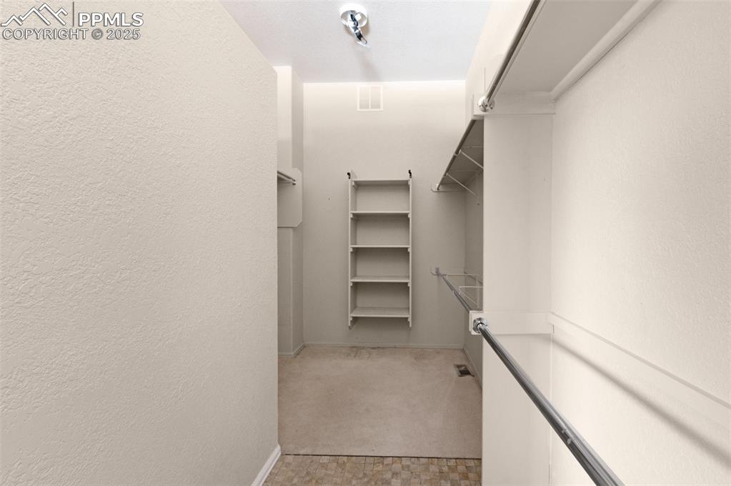 Image 22 of 43: Extra Large Master Walk-in Closet