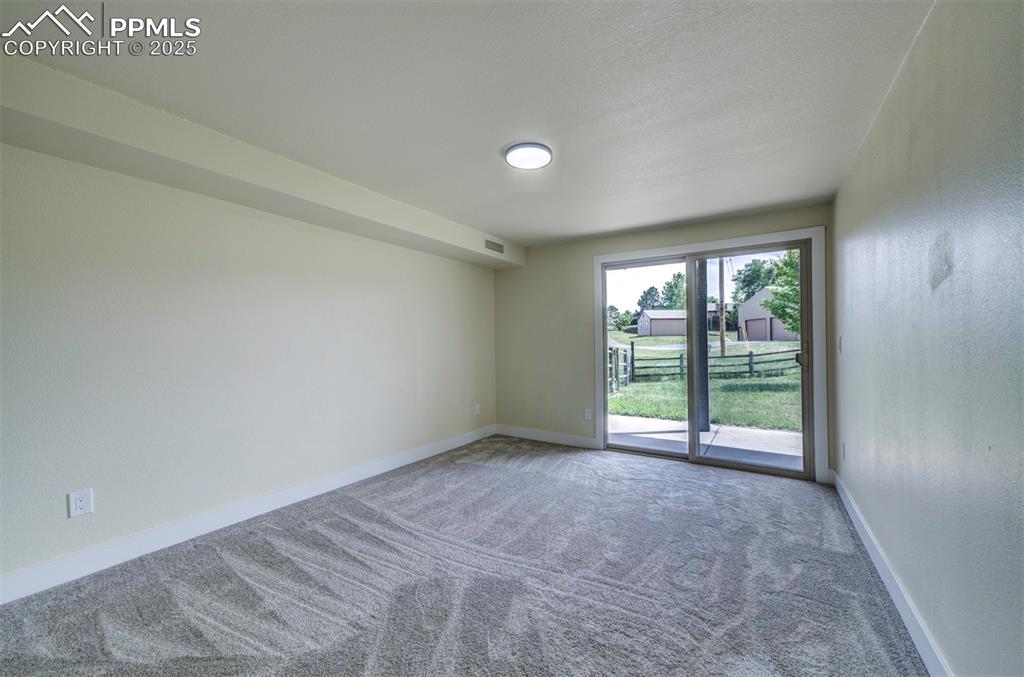 Image 45 of 50: Basement bedroom with walkout