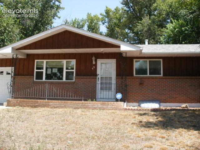 Image 1 of 35: Red brick and wood-paneled exterior with white trim