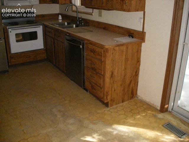 Image 16 of 35: Wood-finish cabinetry with coordinating laminate countertops, double basin