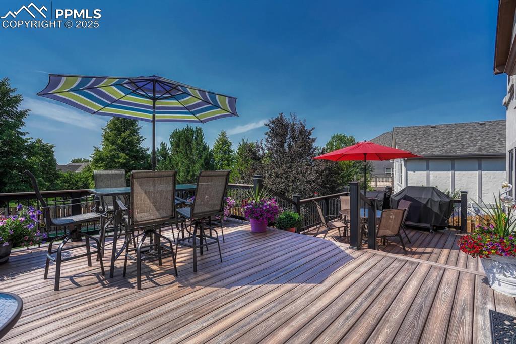 Image 42 of 50: Deck with outdoor dining space and grilling area