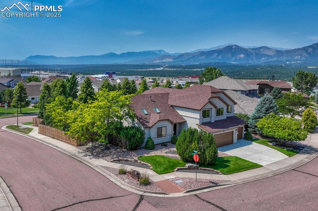 Image 48 of 50: Aerial view of residential area featuring a mountain backdrop