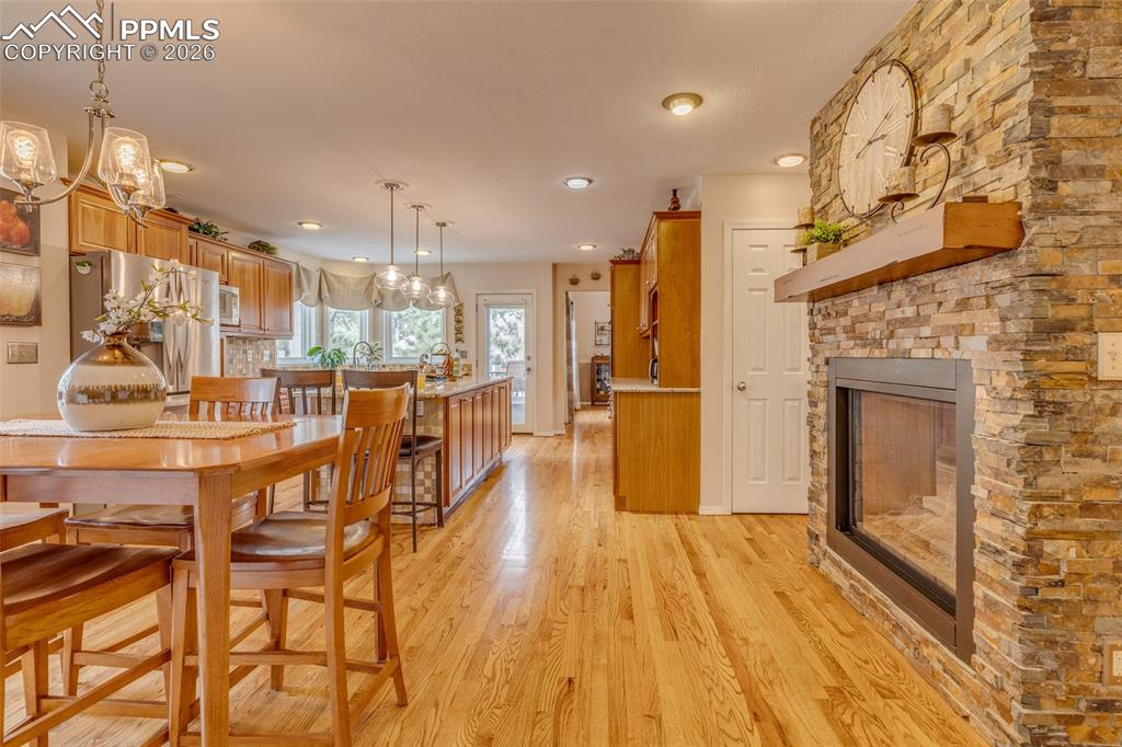 Image 20 of 50: Double fireplace, beautiful wood floors