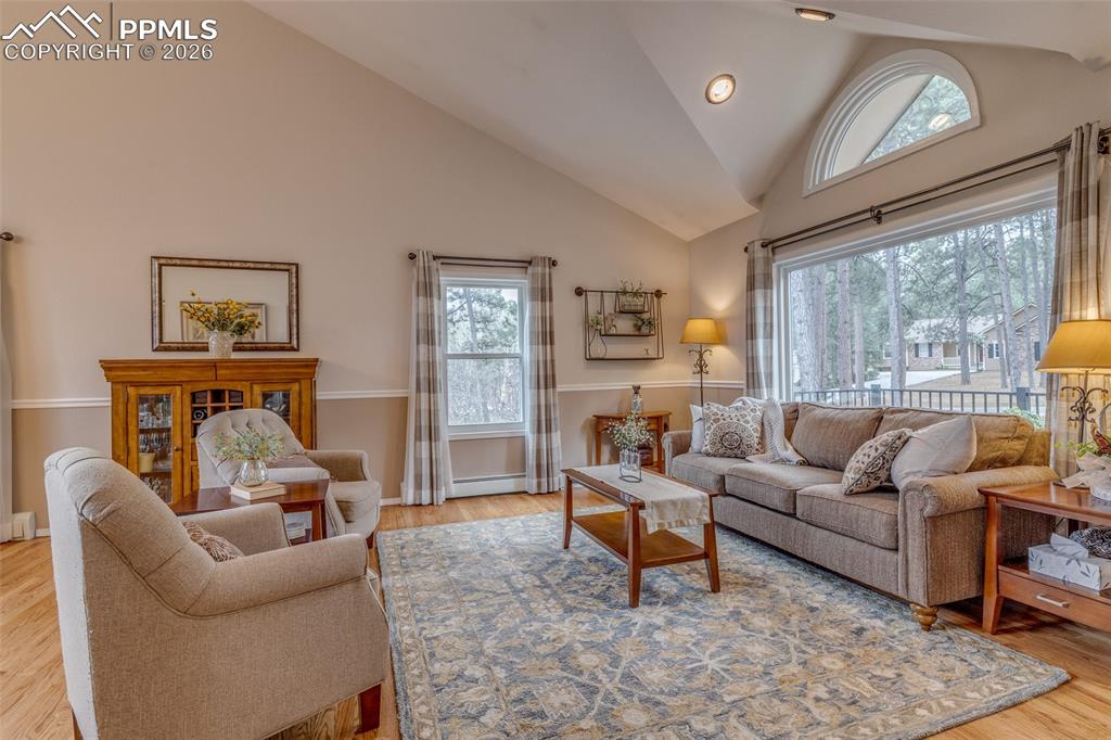 Image 3 of 50: Living room with vaulted ceilings