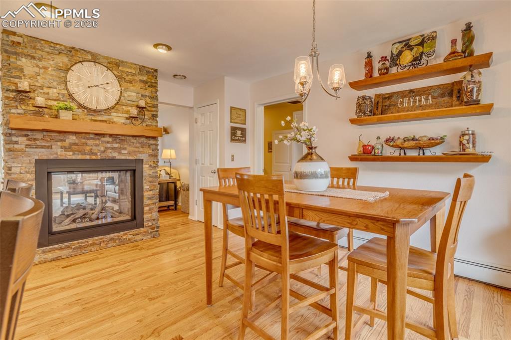 Image 6 of 50: Kitchen dining area by double sided fireplace