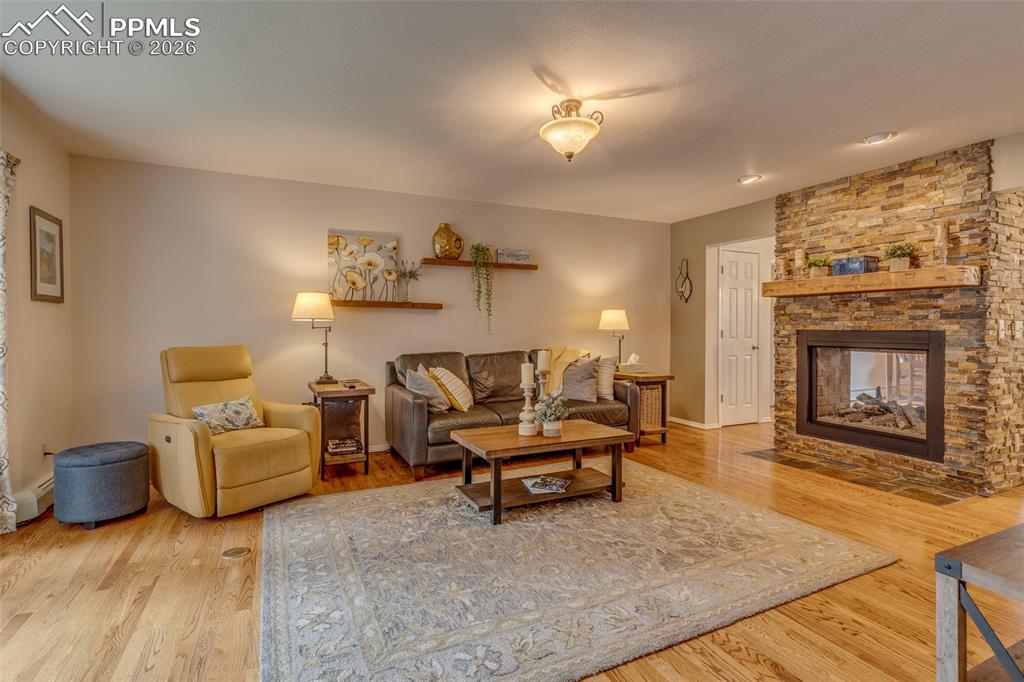 Image 7 of 50: Family room by the double sided fireplace