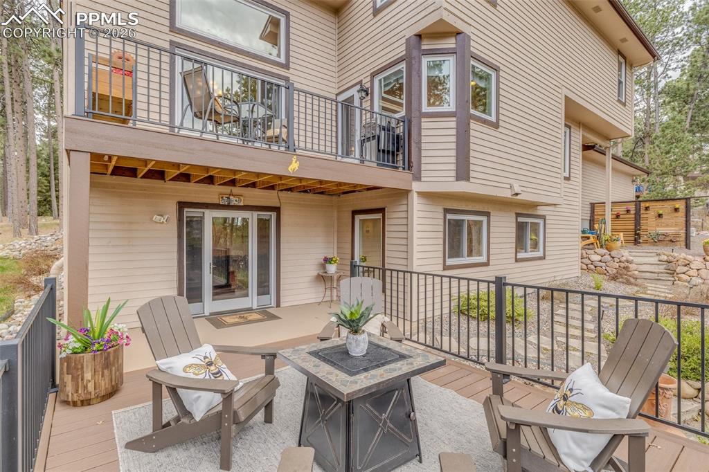 Image 8 of 50: Back of the home showcasing two of the balconies