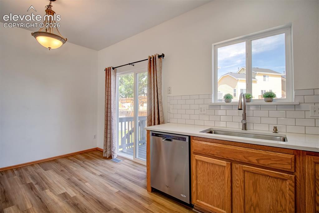 Image 13 of 37: Another view from kitchen looking toward dining area and deck access.