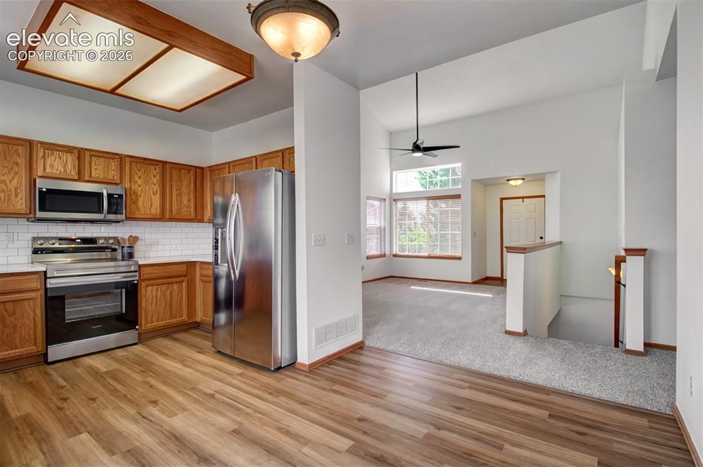 Image 14 of 37: Kitchen/dining area view from sliding doors... you can see the front-door e