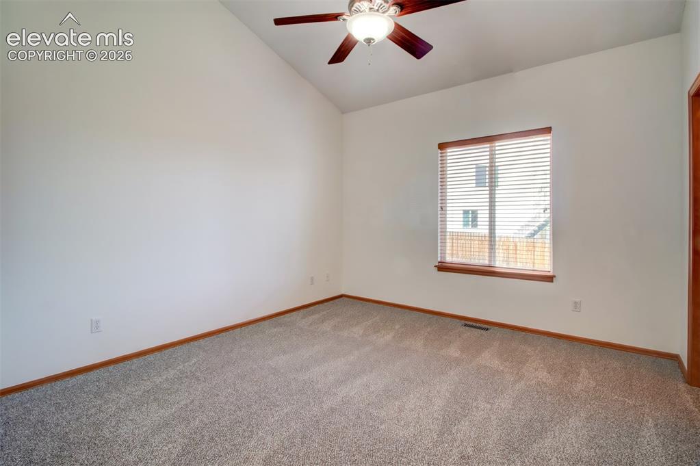 Image 15 of 37: Main-level primary bedroom with vaulted ceiling and walk-in closet adjoins 