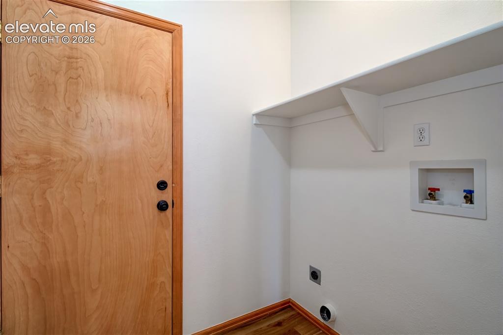 Image 21 of 37: Main-level laundry space with access to the garage.