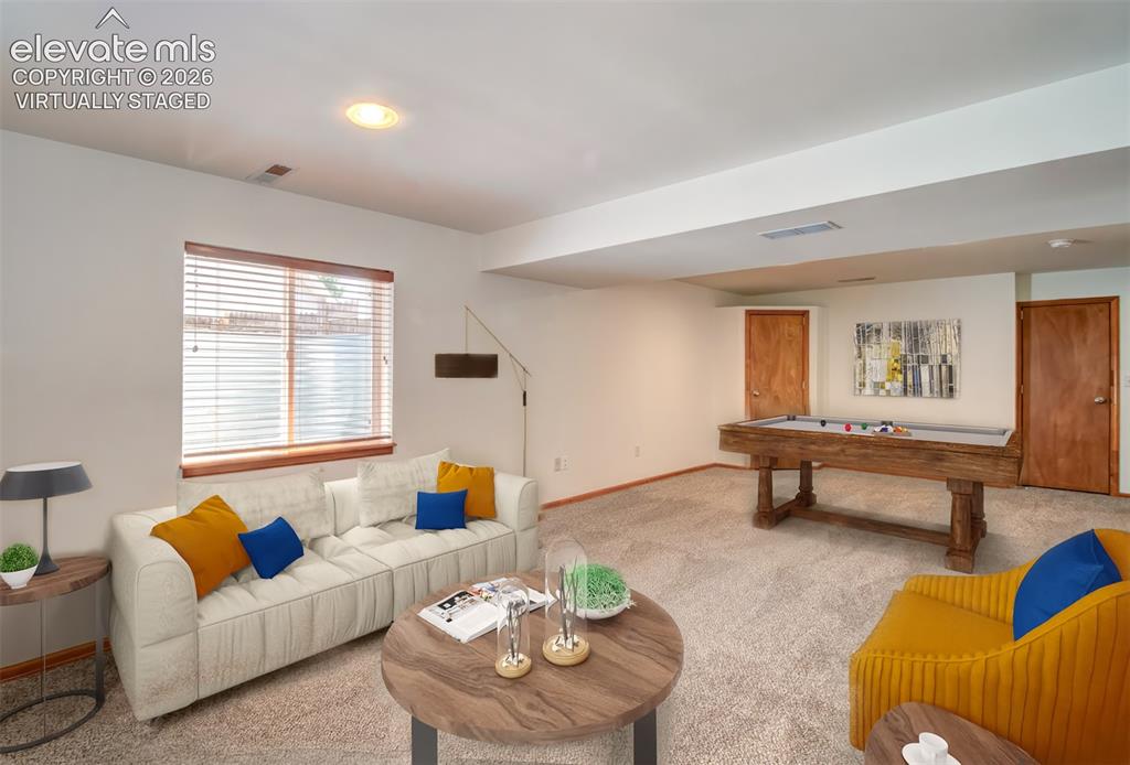 Image 23 of 37: Virtually Staged basement-level family room.