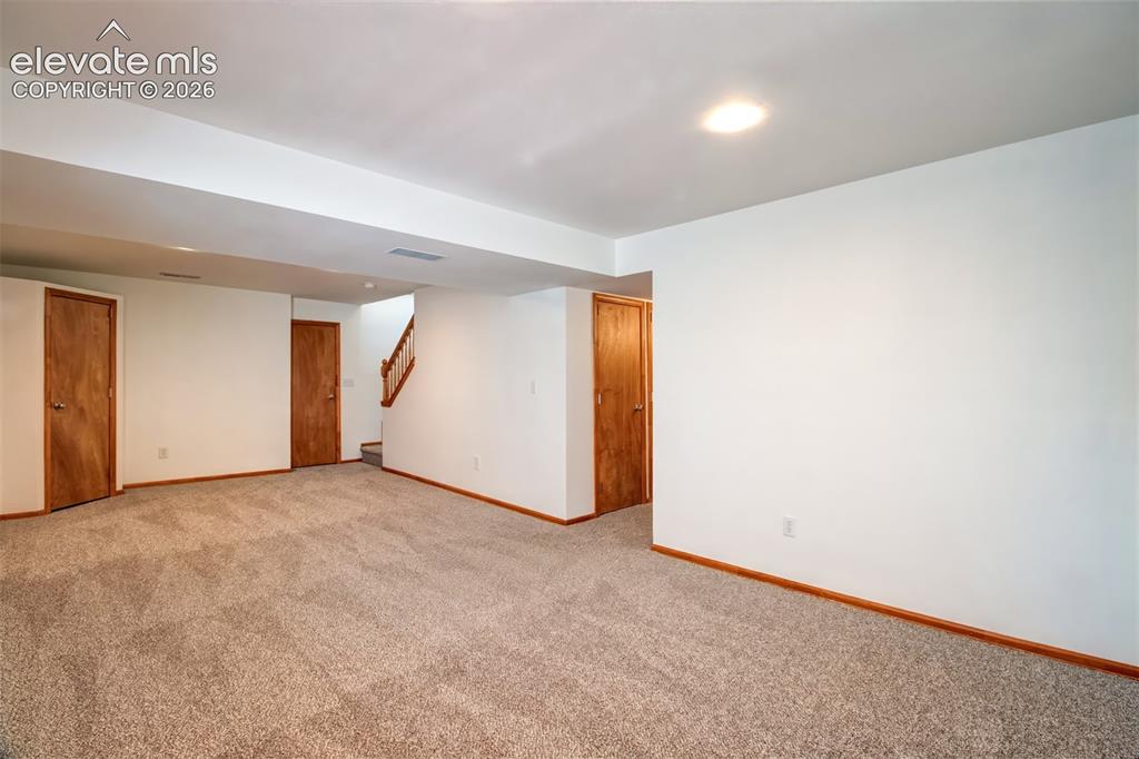 Image 24 of 37: Another view of the basement-level family room.