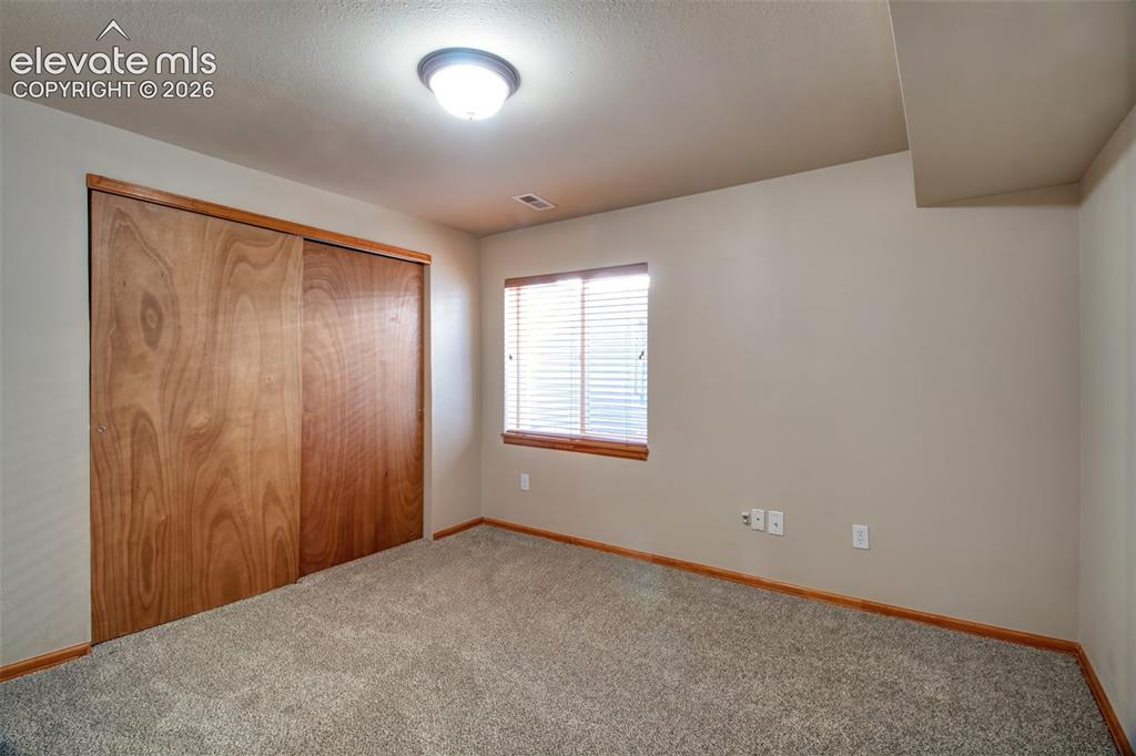 Image 29 of 37: Fourth bedroom in the basement level.