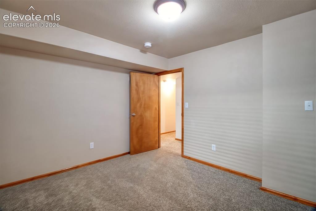 Image 30 of 37: Another view of the fourth basement-level bedroom.