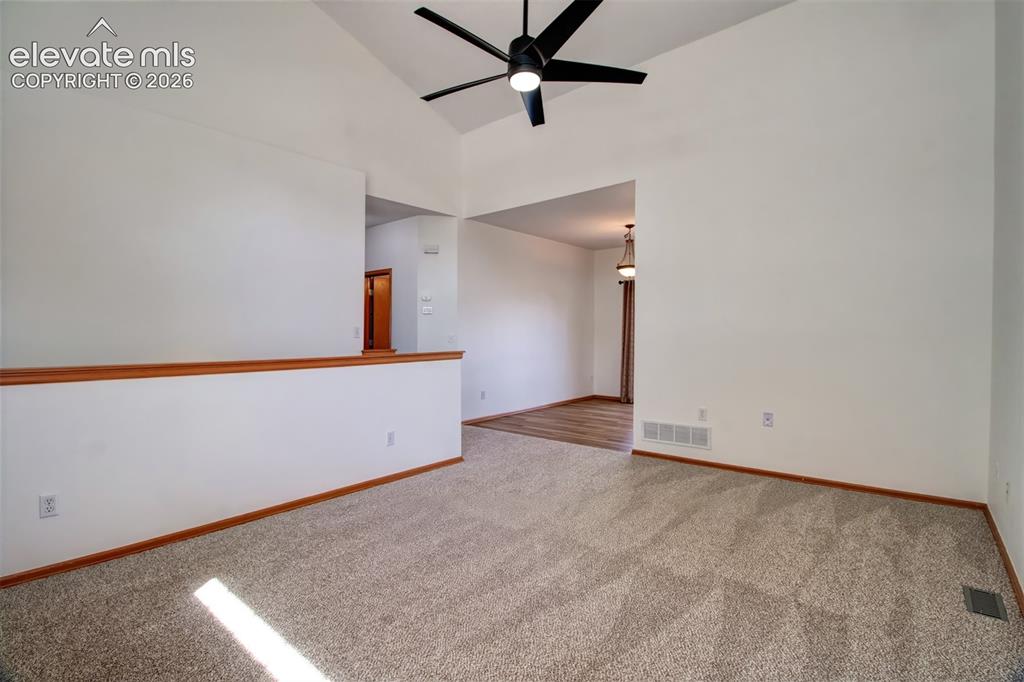Image 4 of 37: Another view of the living room as you look toward dining area and stairwel