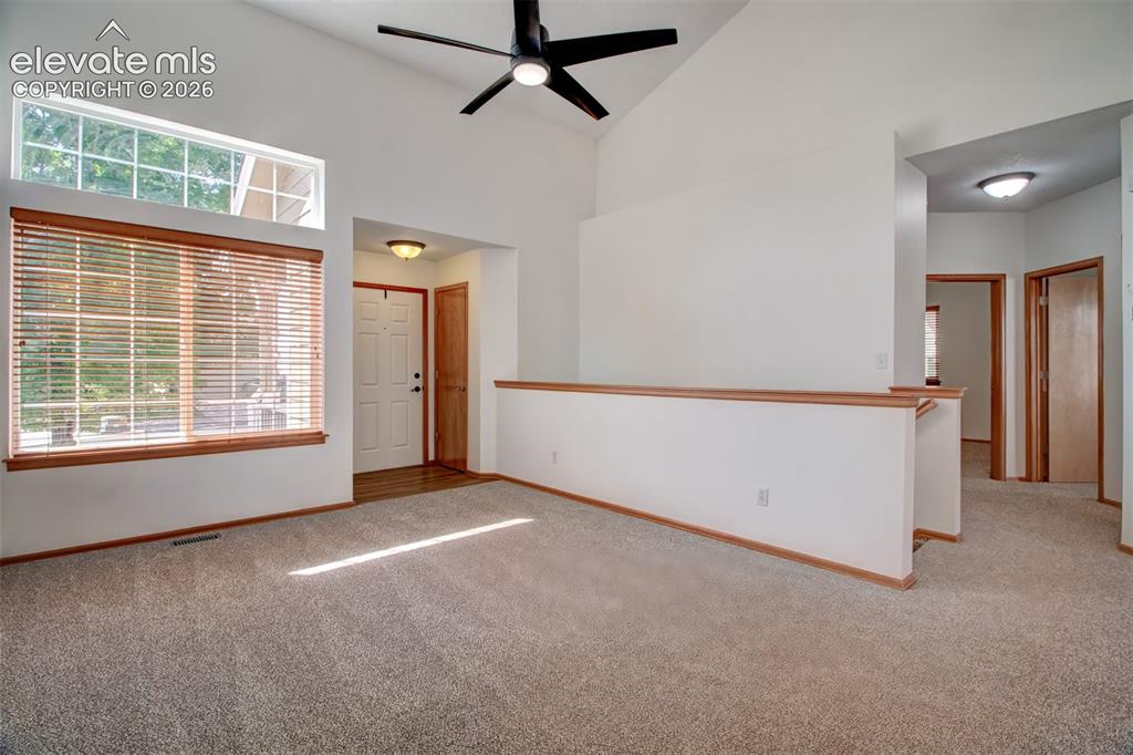 Image 5 of 37: Living room, opposite view looking toward front door. You can also see two 