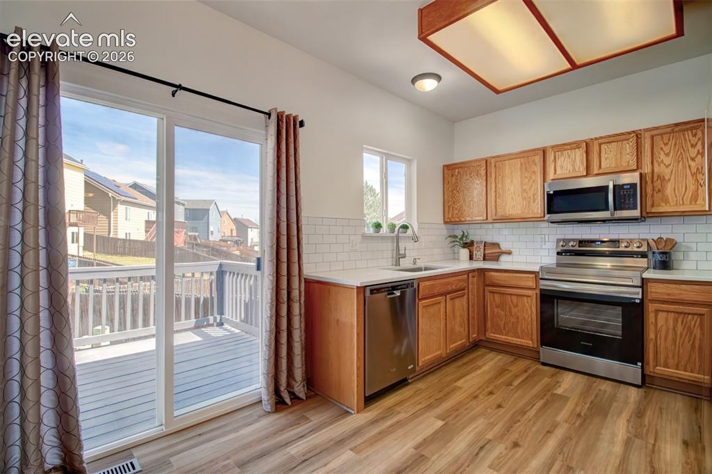 Image 8 of 37: Dining area looking toward kitchen. You can also see the walk-out access to