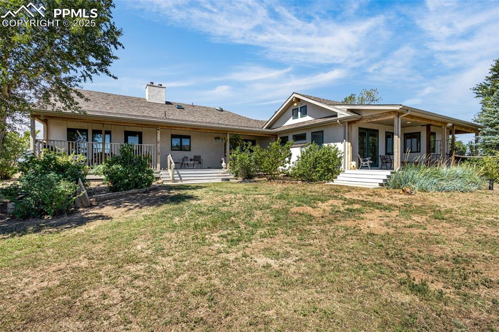 Image 42 of 50: Back deck and fenced in yard
