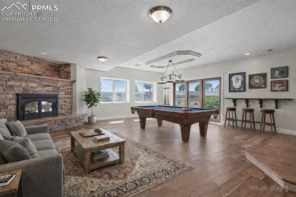 Image 31 of 50: Virtually Staged -Basement Walk-Out Family Room w/Pellet Stove and Vintage 