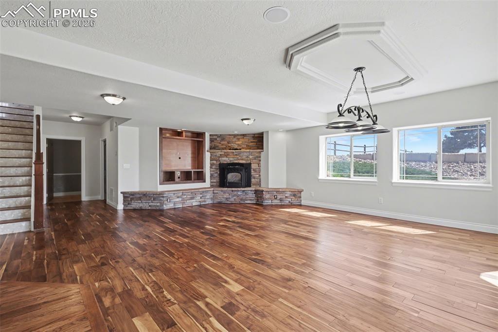 Image 33 of 50: Basement Walk-Out Family Room w/Pellet Stove and Vintage Bar