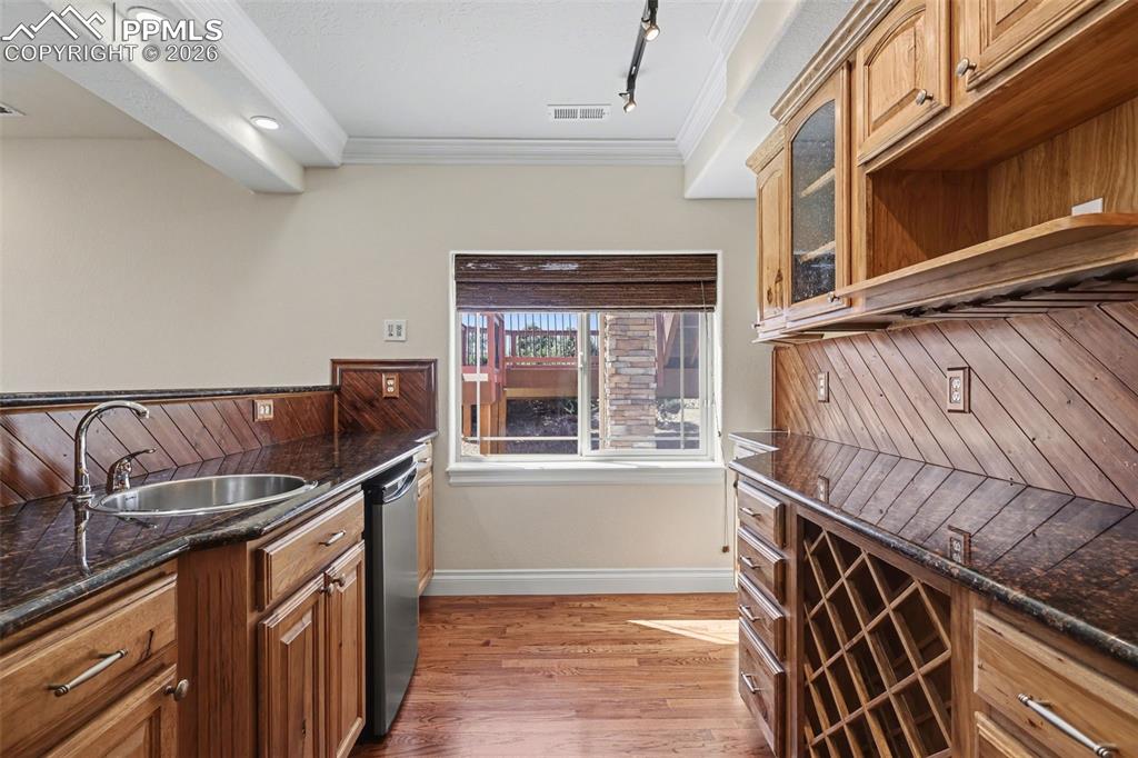 Image 35 of 50: Basement Walk-Out Family Room w/Pellet Stove and Vintage Bar