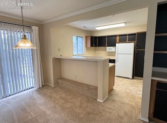 Image 12 of 32: Looking towards kitchen featuring white appliances, a breakfast bar, light 