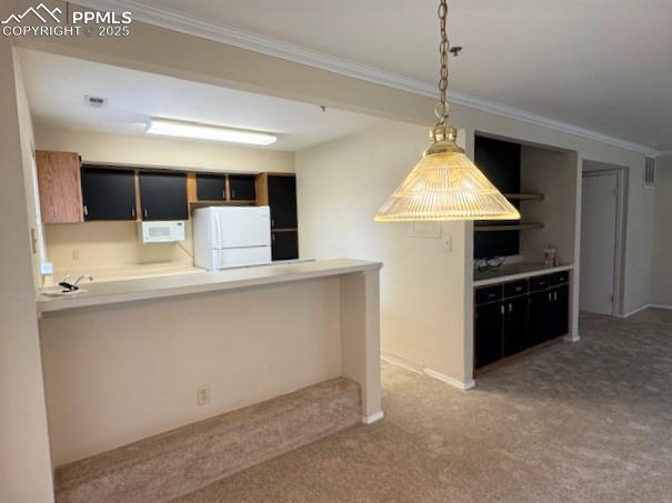 Image 13 of 32: Another view looking towards the kitchen featuring crown molding, decorativ