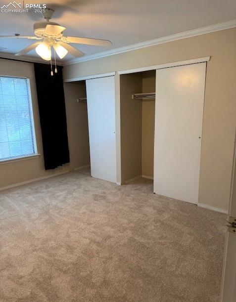 Image 18 of 32: Main bedroom features two closets, crown molding, new, light carpet, and ce
