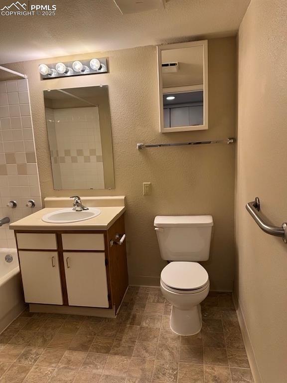 Image 20 of 32: Entry to spacious bathroom with vanity storage and grab bar