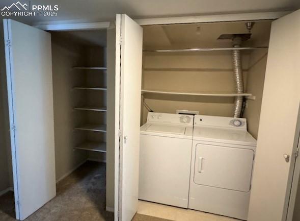 Image 24 of 32: Laundry area with washer and dryer and roomy storage closet to the left