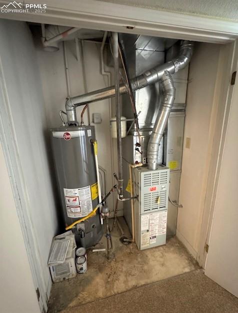 Image 26 of 32: Utility room with water heater and furnace unit