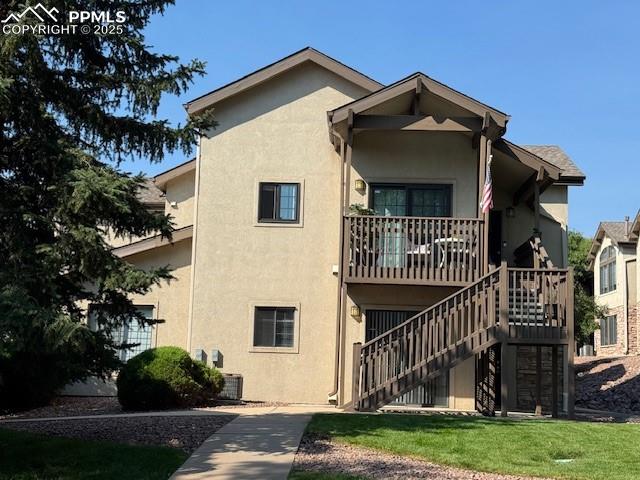 Image 3 of 32: View of building exterior showing stairway to above unit.