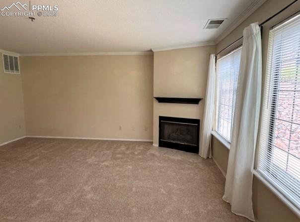 Image 4 of 32: Living room view from inside the front door featuring new, light colored ca