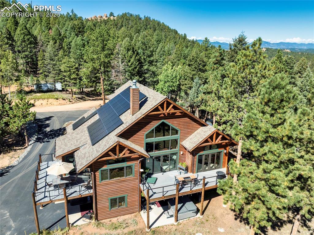 Caption: Remember that mountain log cabin, surrounded by trees and rock outcroppings, nestled in the trees th