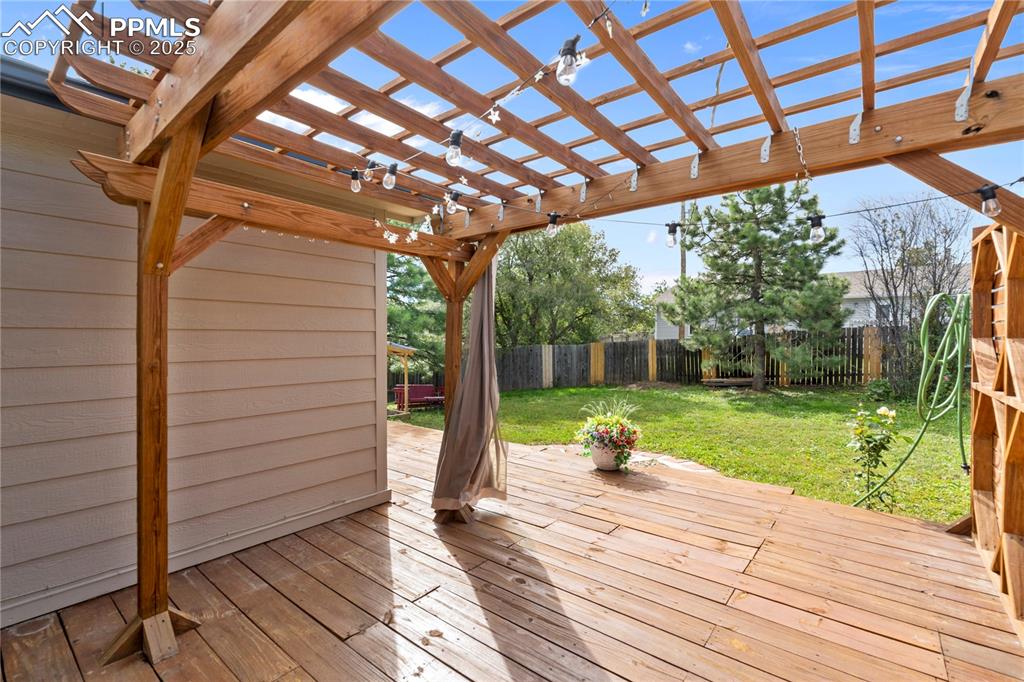 Image 24 of 37: Pergola and drapes for privacy!