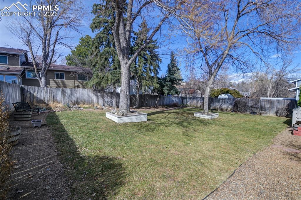 Image 11 of 41: Fenced backyard featuring a garden