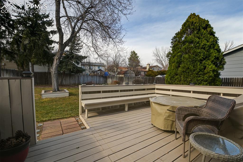Image 9 of 41: Wooden deck with a fenced backyard