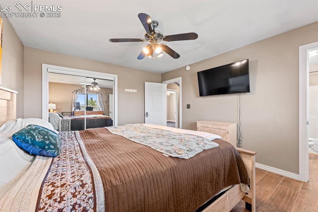Image 12 of 39: Bedroom featuring wood-style tile floors, and a closet.