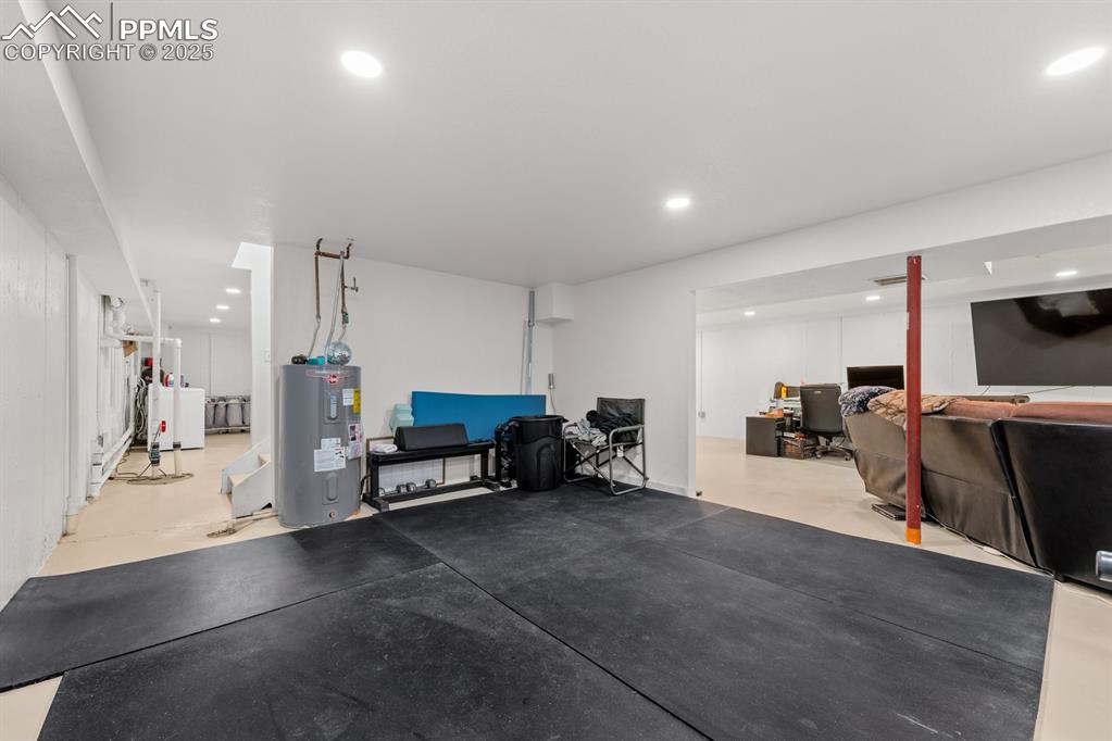Image 22 of 39: Exercise room featuring water heater and recessed lighting