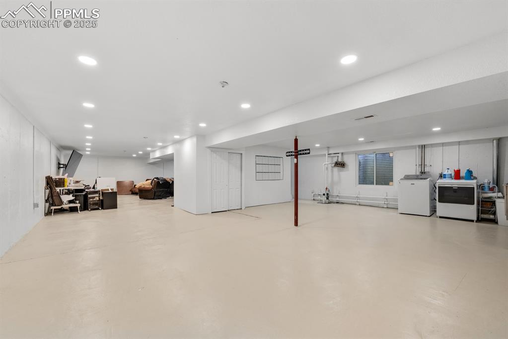 Image 27 of 39: Basement featuring washing machine and clothes dryer and recessed lighting