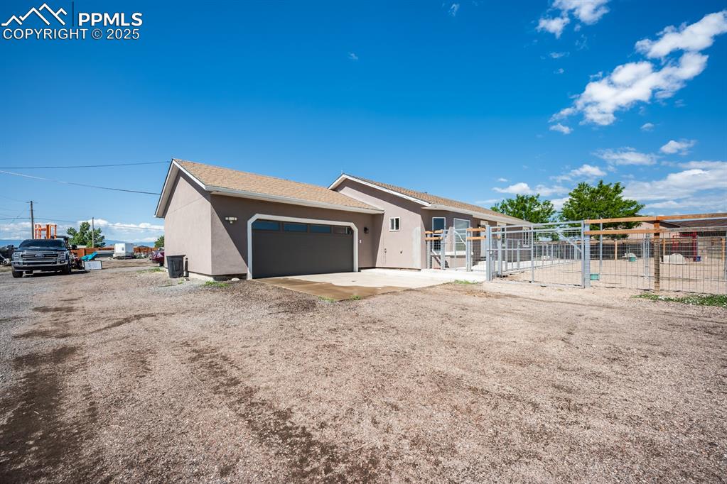 Image 3 of 39: View of front of house featuring stucco siding, an attached garage, and a g
