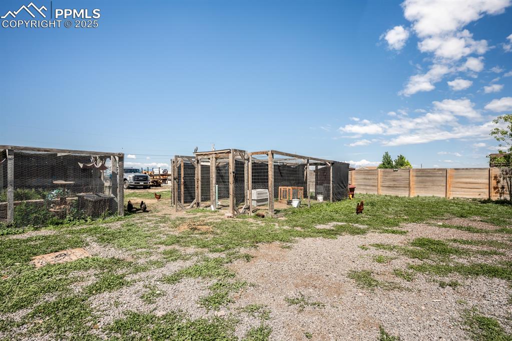 Image 31 of 39: View of yard featuring exterior structure and an outbuilding