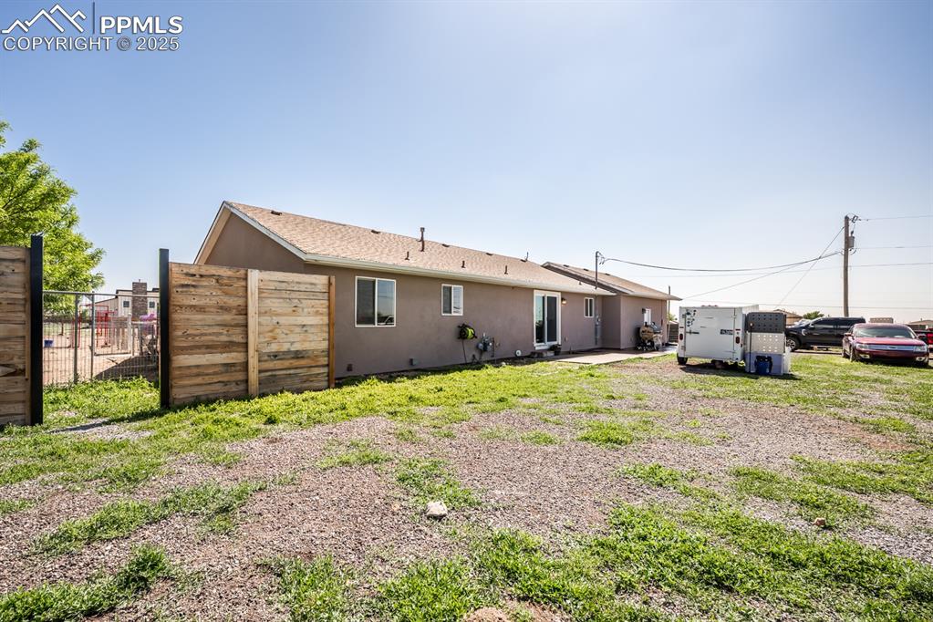 Image 32 of 39: Rear view of house with stucco siding