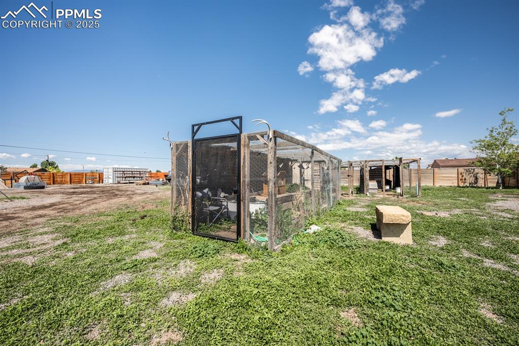 Image 33 of 39: View of yard featuring exterior structure and an outdoor structure