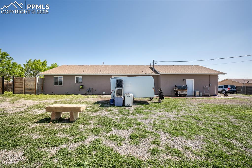 Image 5 of 39: Rear view of property featuring stucco siding