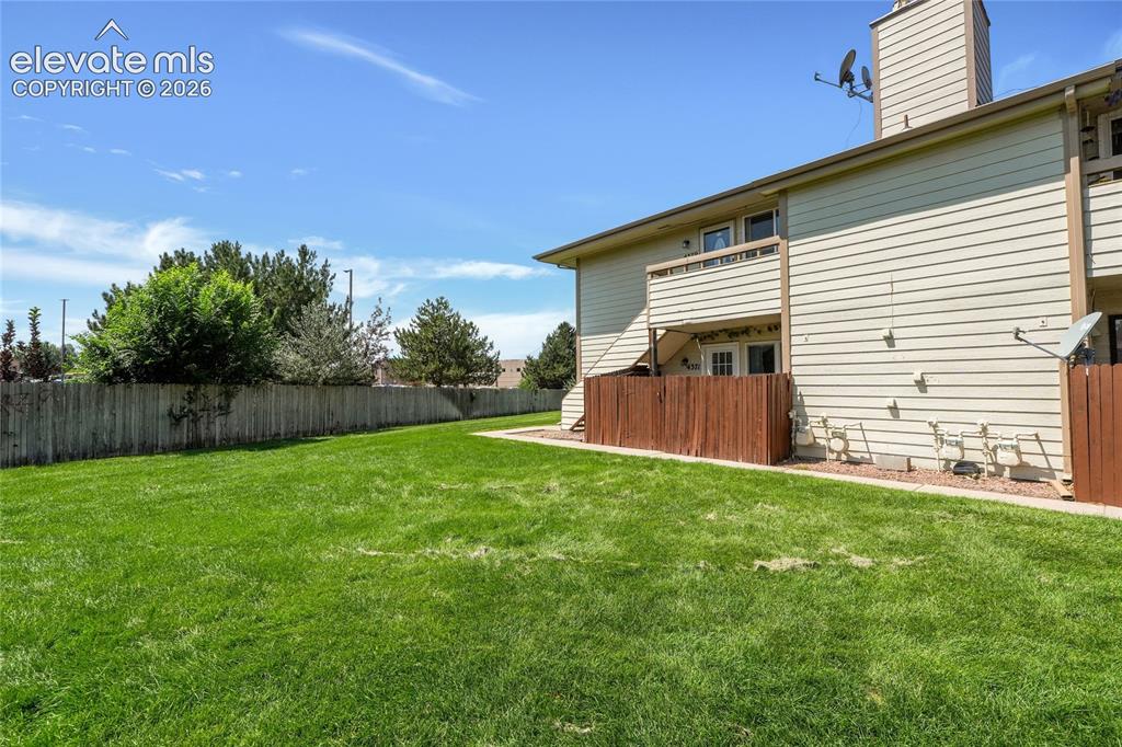 Image 21 of 22: Home is directly off a large grass area 